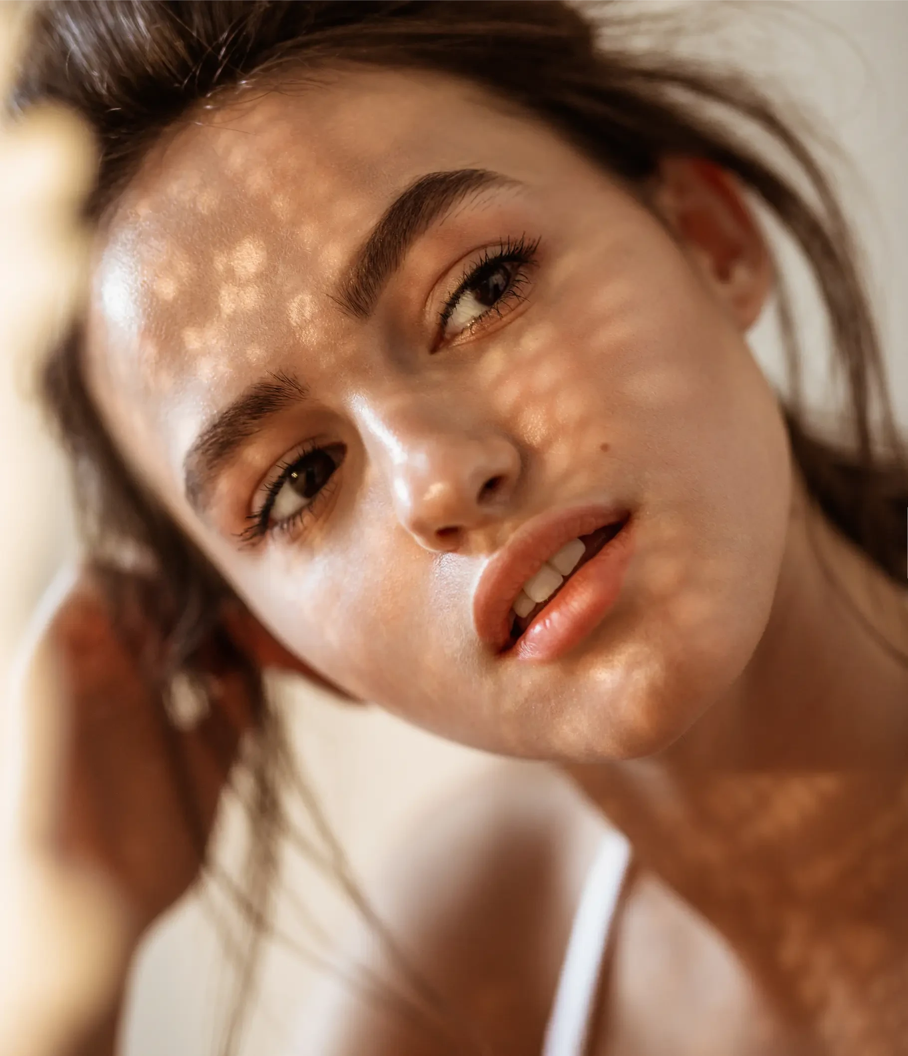 Beautiful woman in a close up portrait at sunset with glowing skin and elegant features